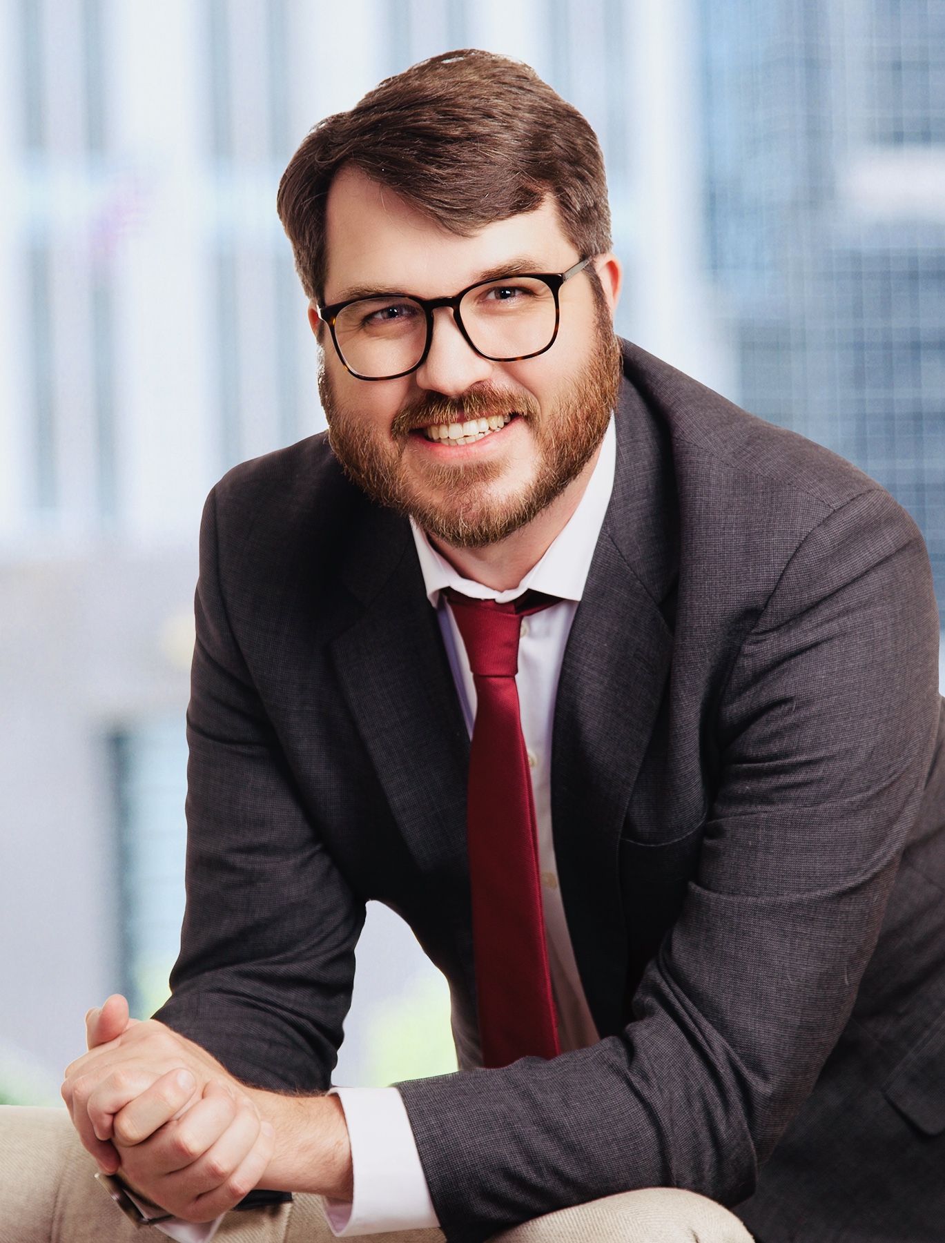 headshot of Tony wearing a sport coat, blue shirt, and tie